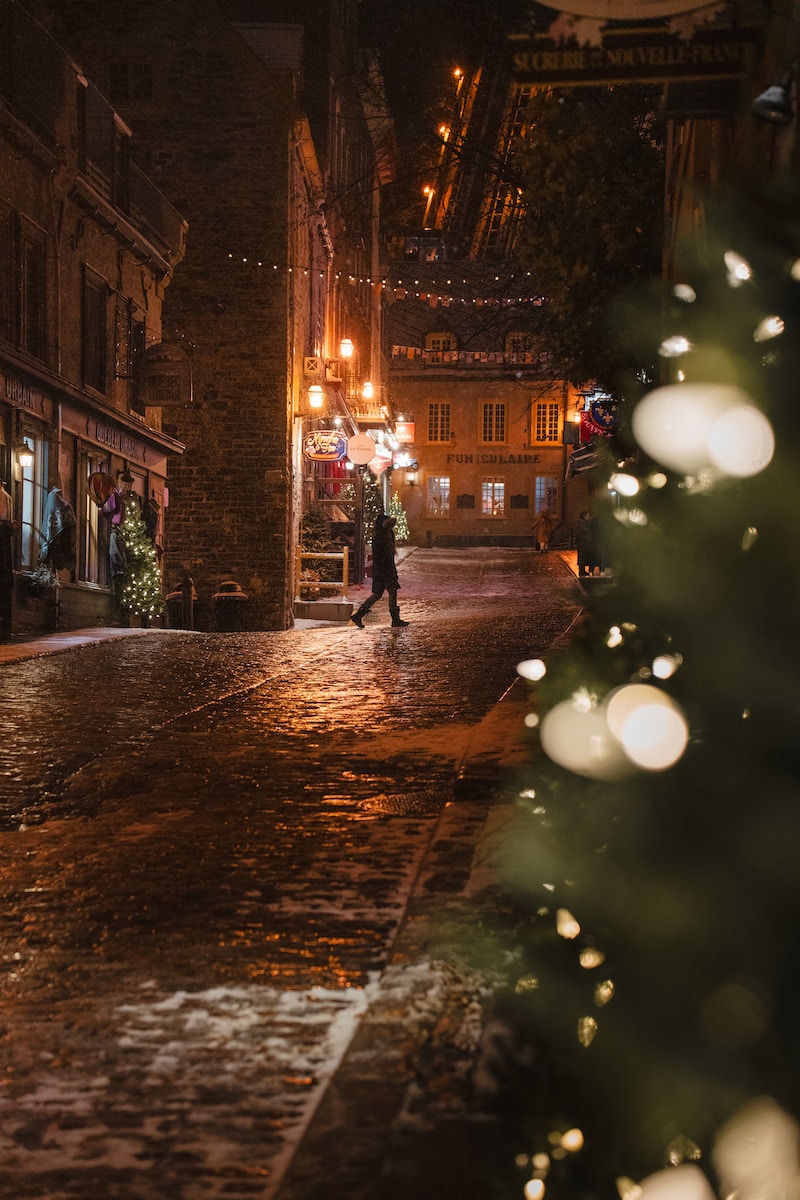 a person walking down a street at night