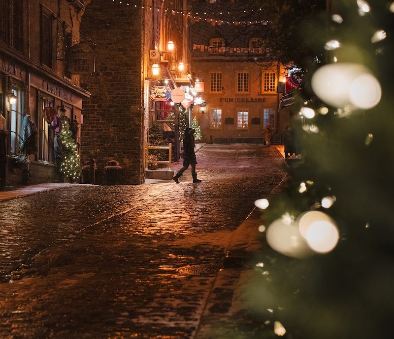 a person walking down a street at night