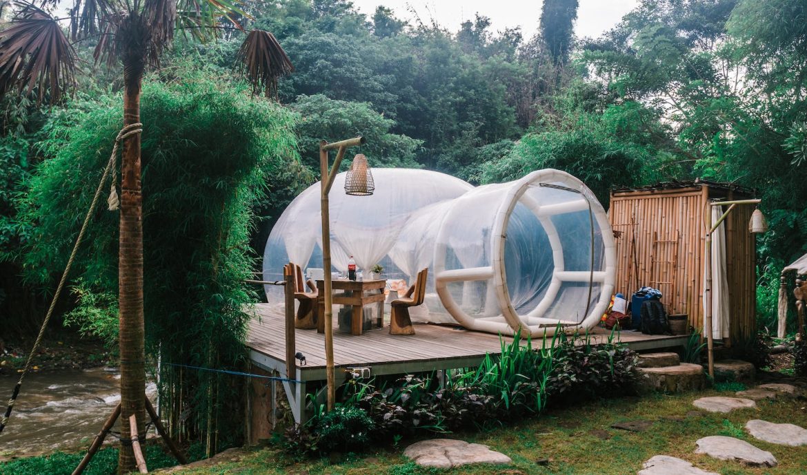 Exterior of cute bubble tent in tropical garden