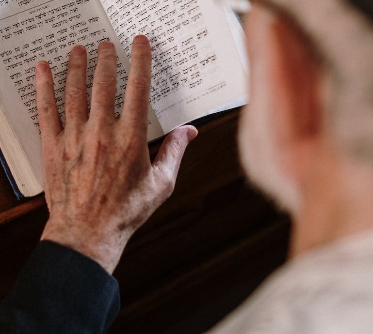 An Elderly Man reading a Chumash