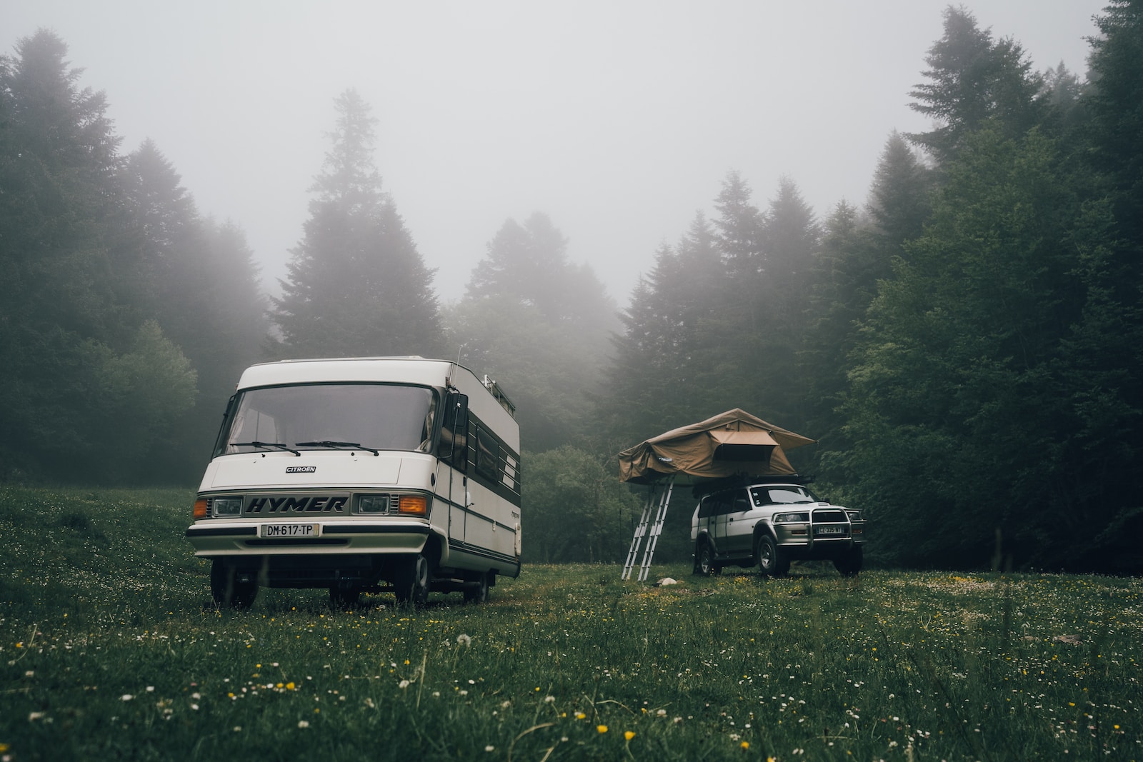 a van and a truck parked in a field