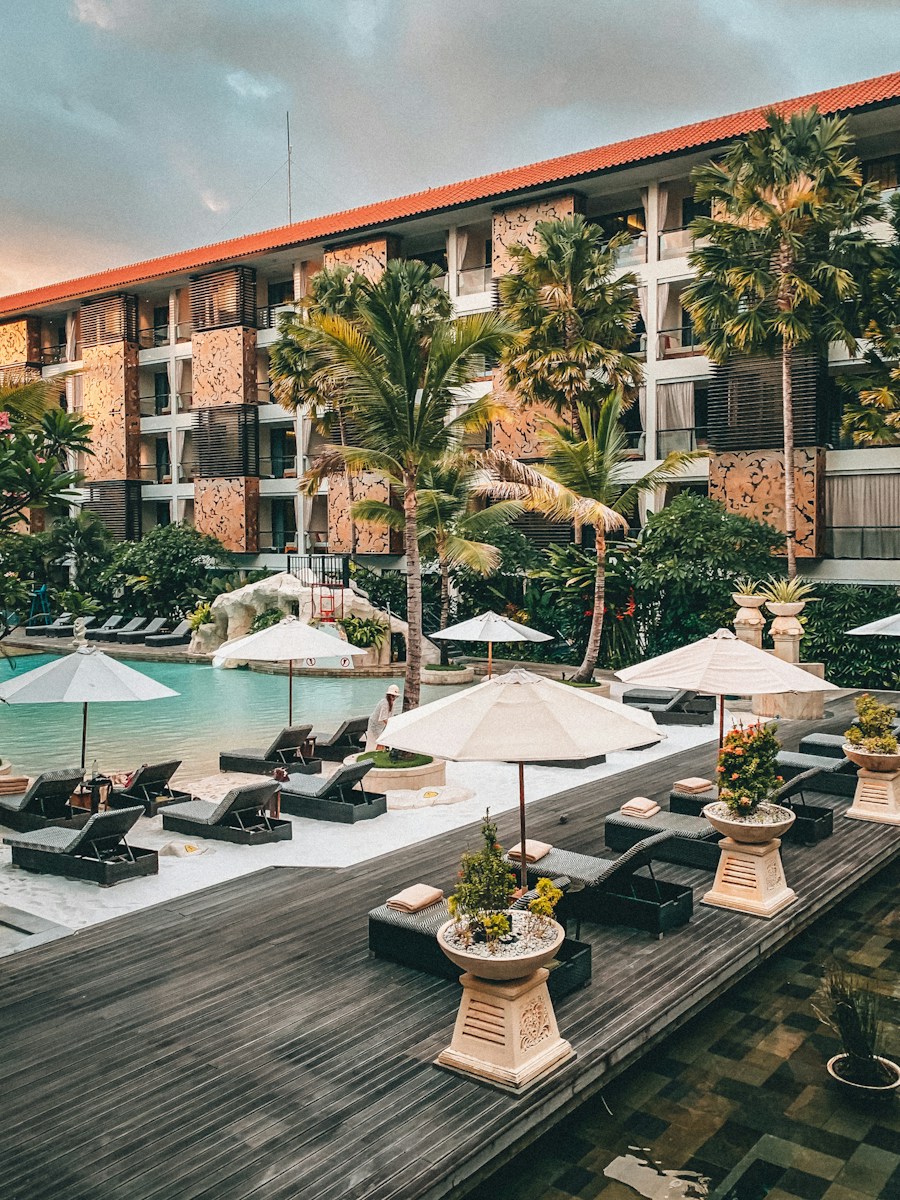 white patio umbrella near swimming pool during daytime