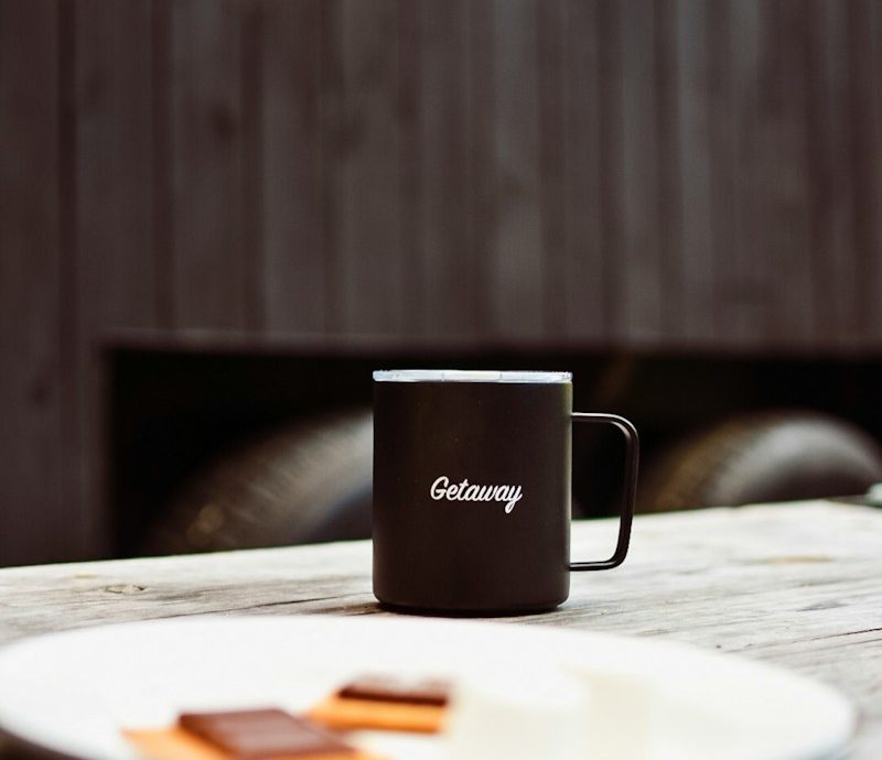 black mug beside plate