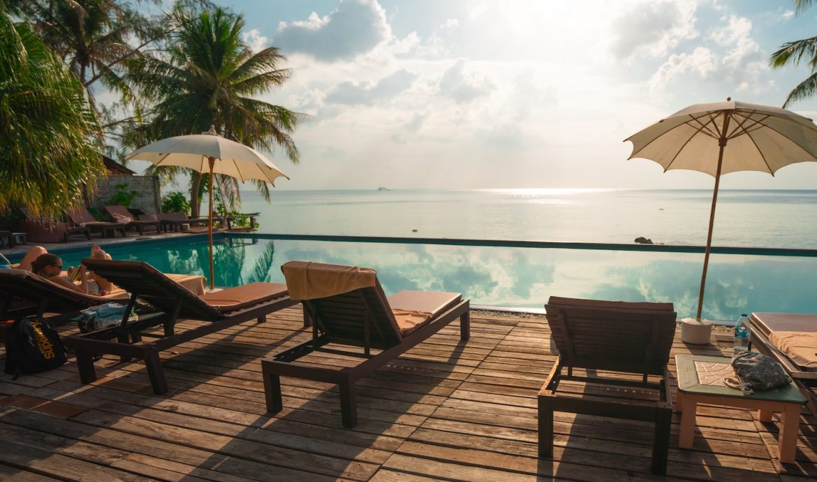 brown wooden lounge chairs on brown wooden dock during daytime