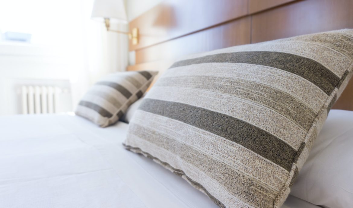 gray and black throw pillow on bed